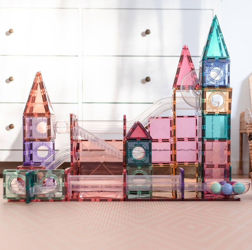 Pastel CONNETIX ball run built from magnetic tiles on a light wooden floor