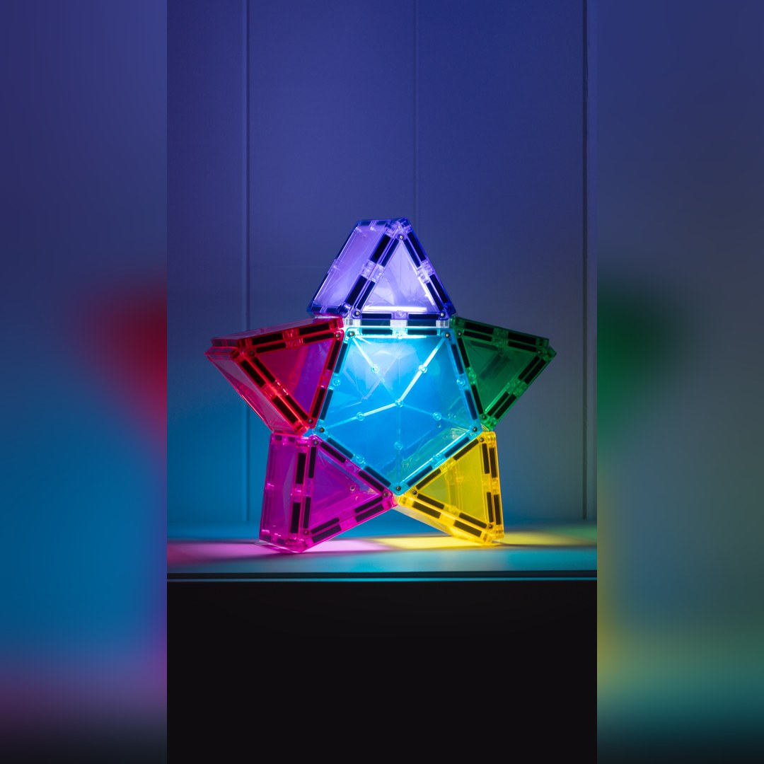 Glowing rainbow star built from CONNETIX magnetic tiles lit by the rechargeable light tile