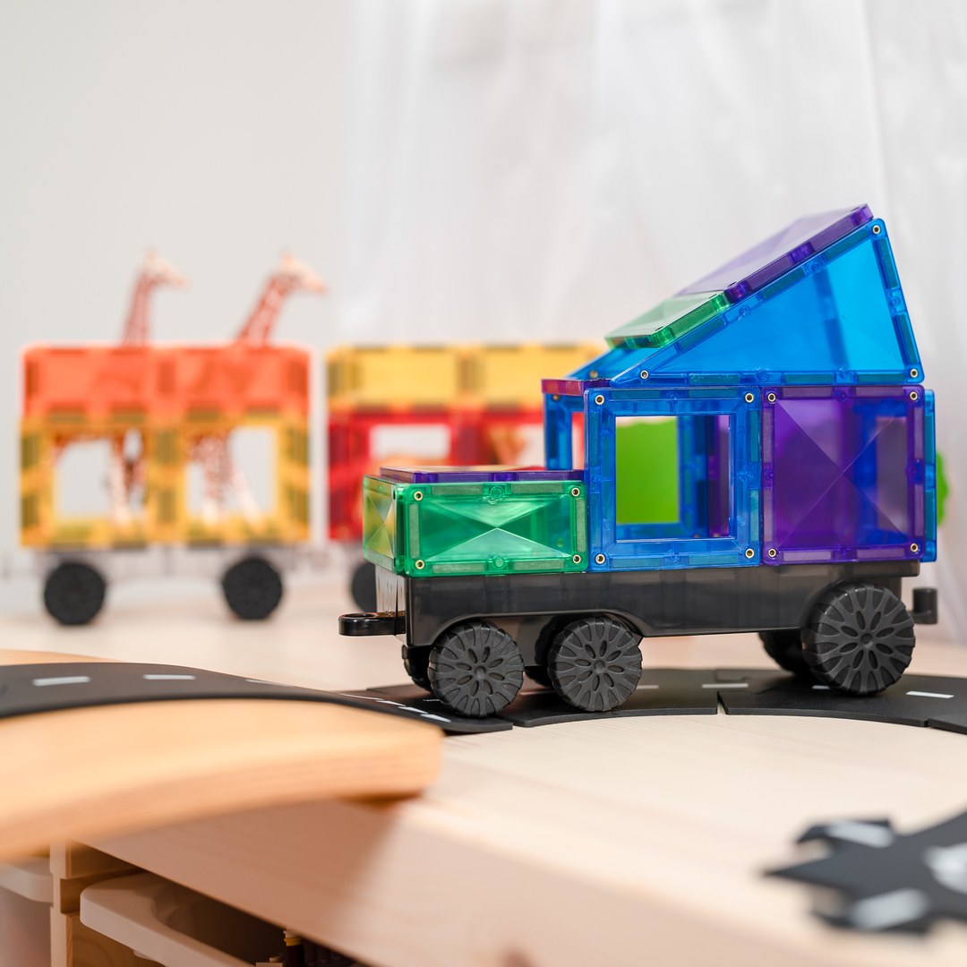 Rainbow CONNETIX magnetic tile truck pulling carriages carrying toy giraffes