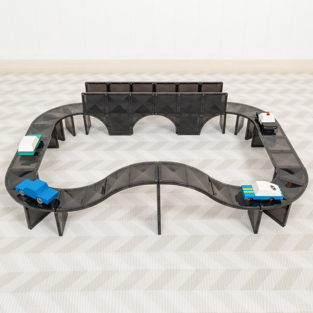 Raised CONNETIX magnetic tile road with an arched bridge and toy cars