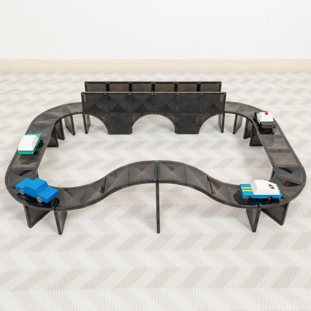 Raised CONNETIX magnetic tile road with an arched bridge and toy cars
