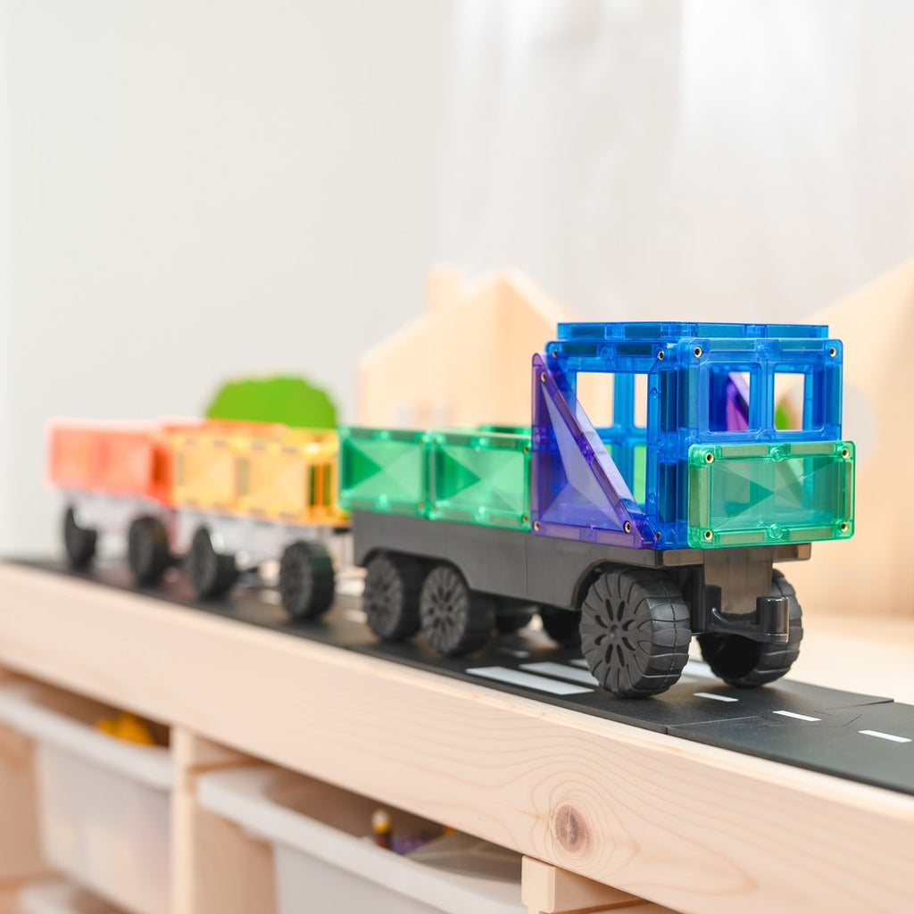 CONNETIX magnetic tile truck pulling rainbow trailers along a play road