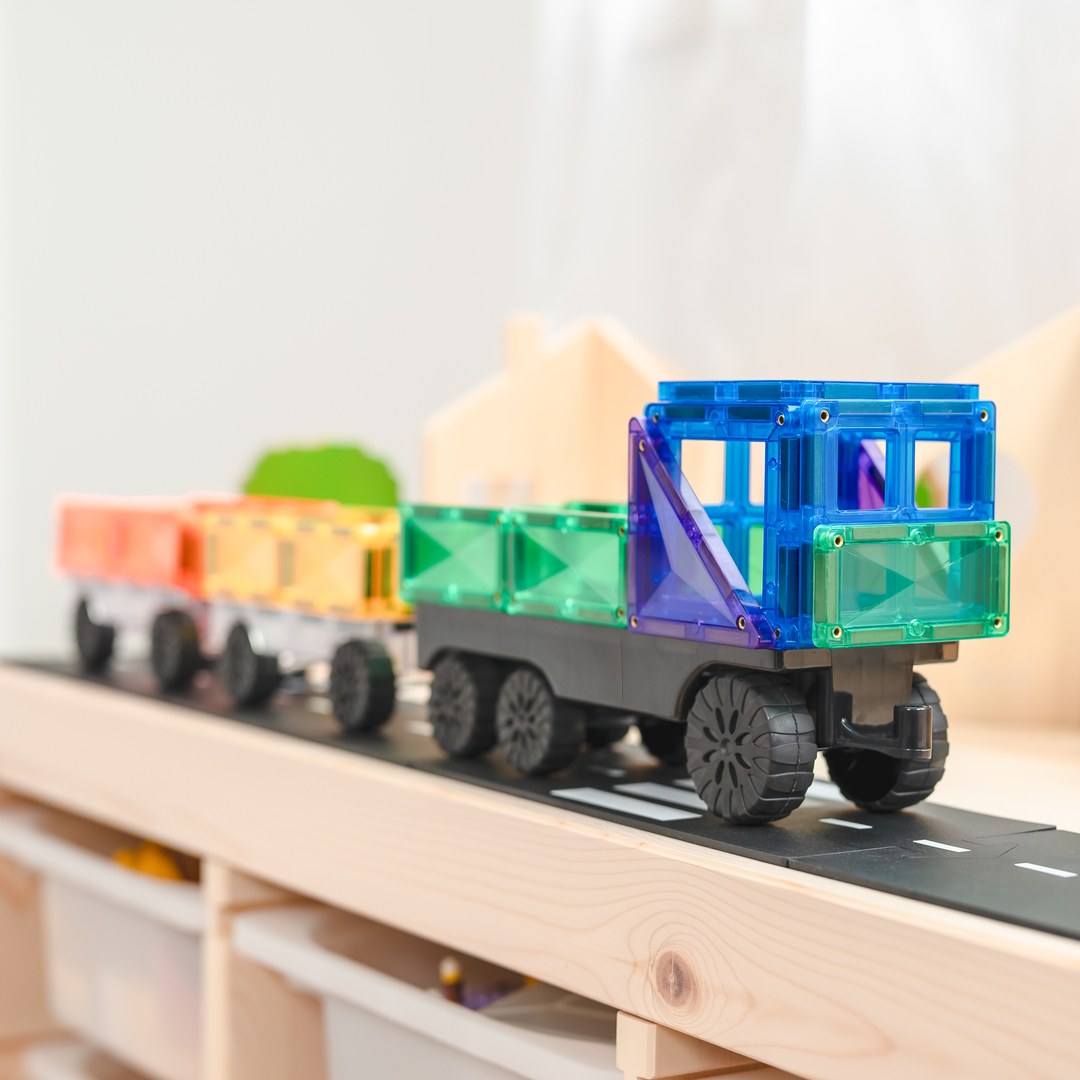 CONNETIX magnetic tile truck pulling rainbow trailers along a play road