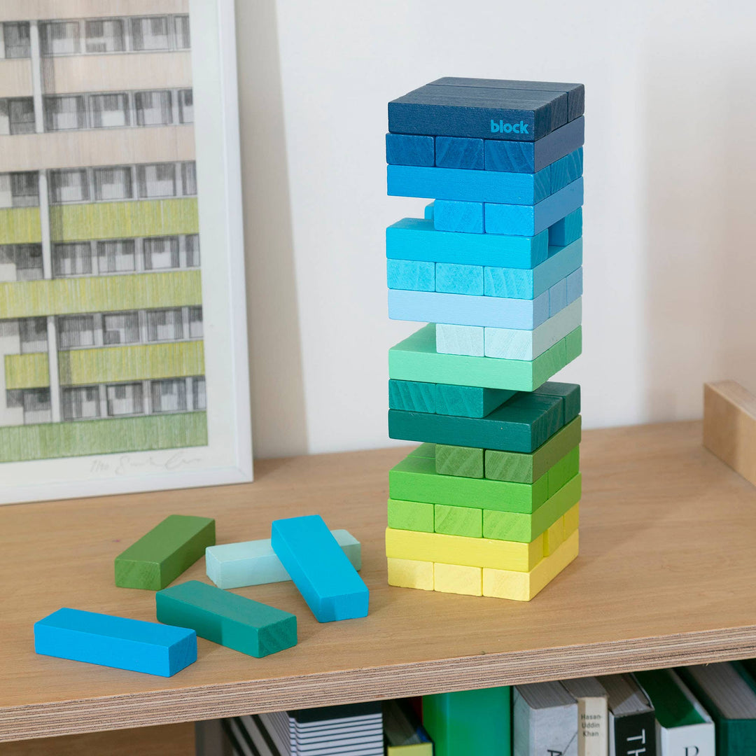 Block Design Warm Gradient Tower, a wooden tumbling tower game with painted blocks in a pink, coral and red gradient, image 3