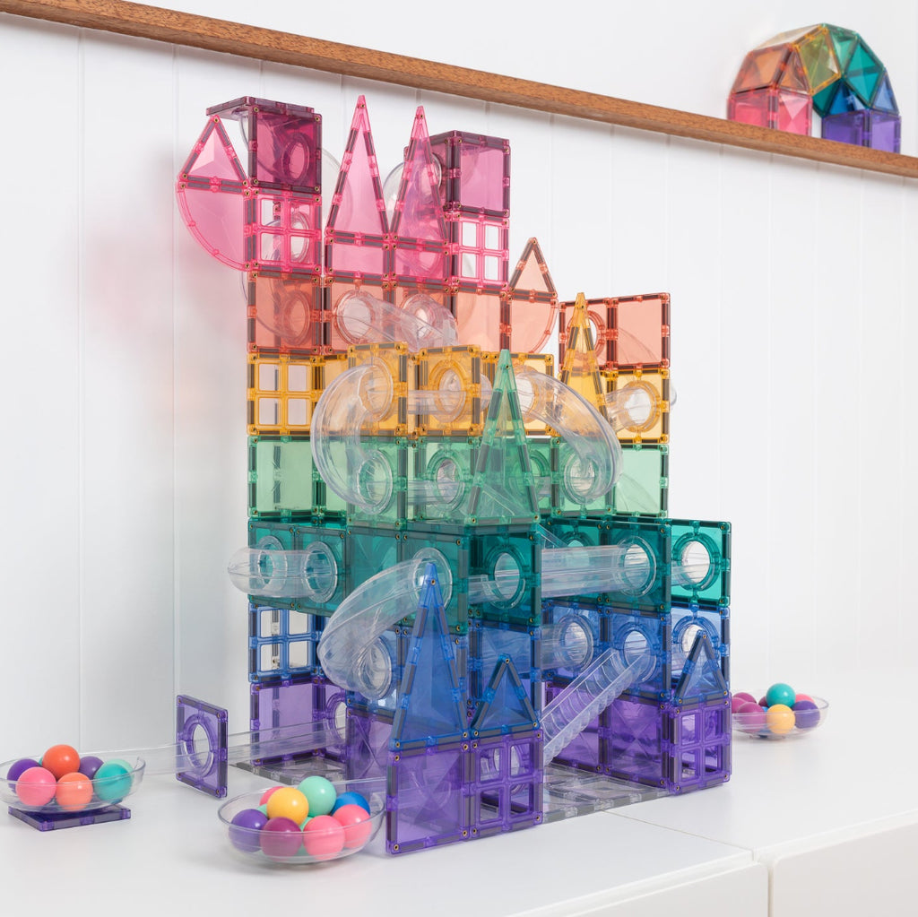 Pastel CONNETIX ball run with stairs and S-bend tubes on a white table