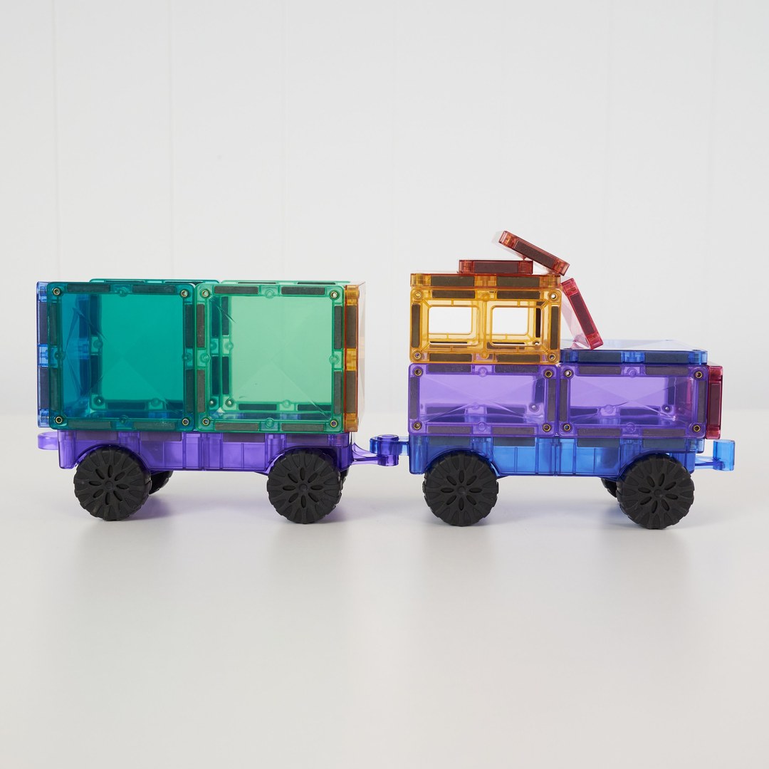 Side view of a pastel CONNETIX truck pulling a trailer on rubber wheels