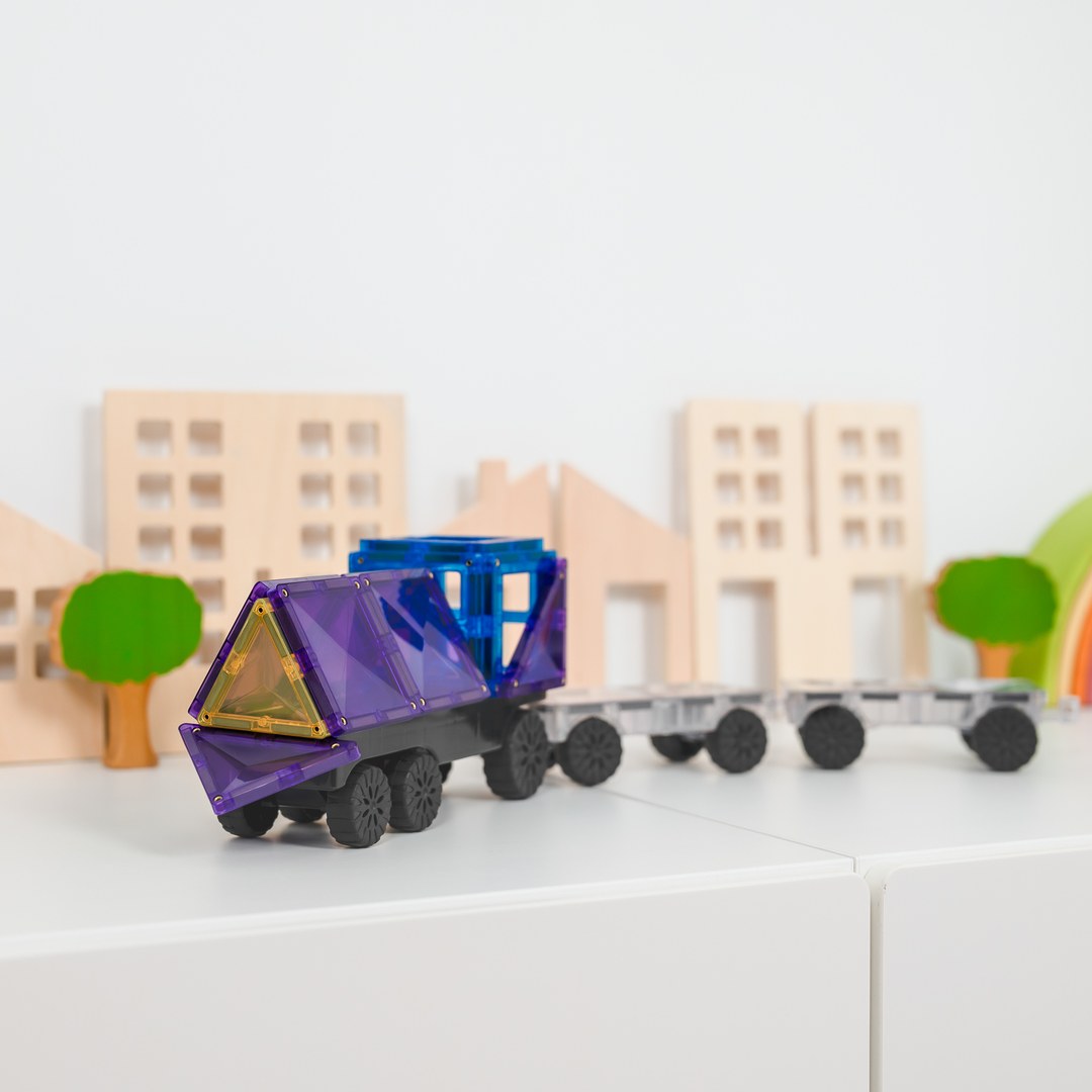 Purple and blue CONNETIX magnetic tile truck with trailers in a toy city