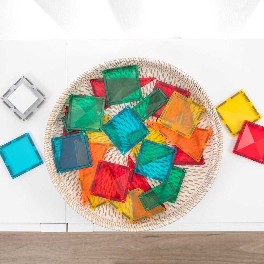 CONNETIX Light Rocket Pack magnetic tiles in a woven basket with the light-up tile beside it