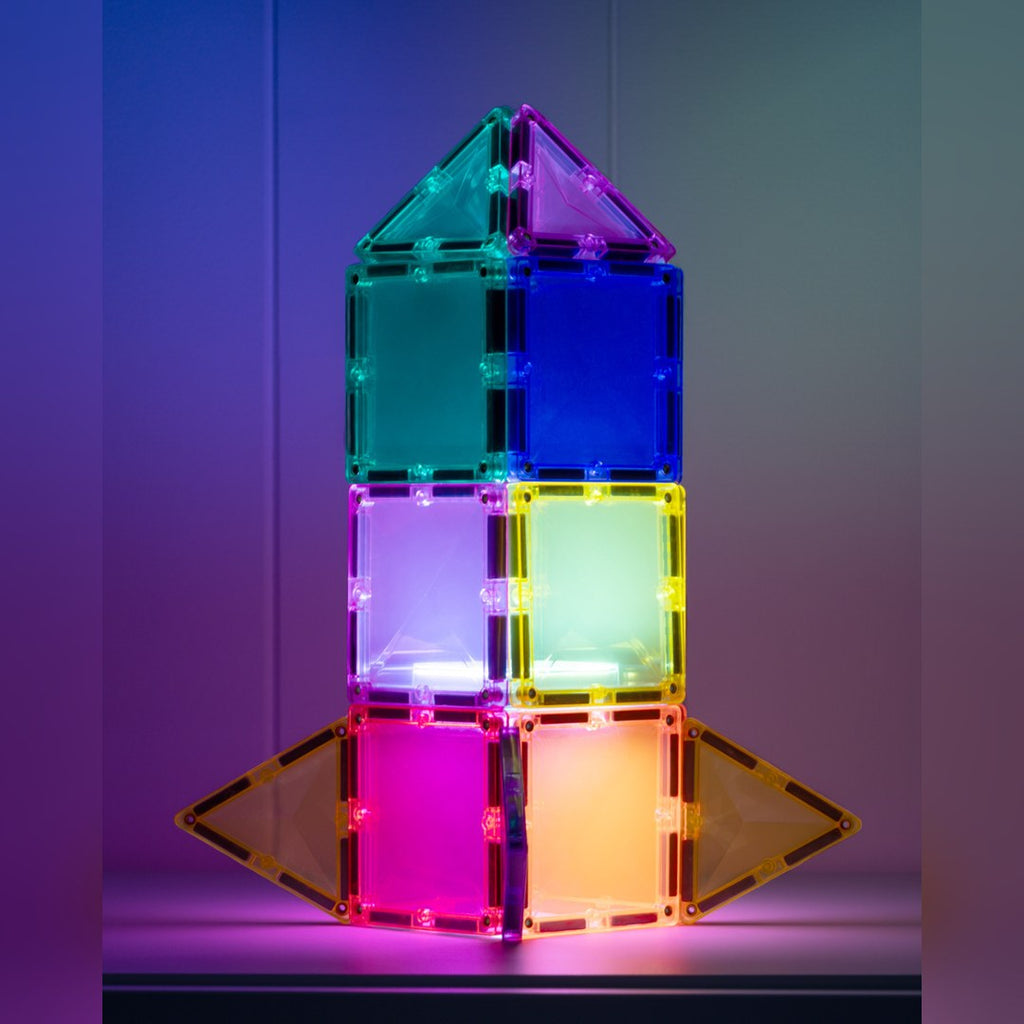 Glowing rocket built from CONNETIX magnetic tiles lit in pink, purple and green