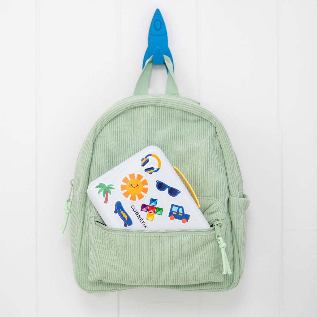 CONNETIX travel tin tucked into a child's backpack pocket
