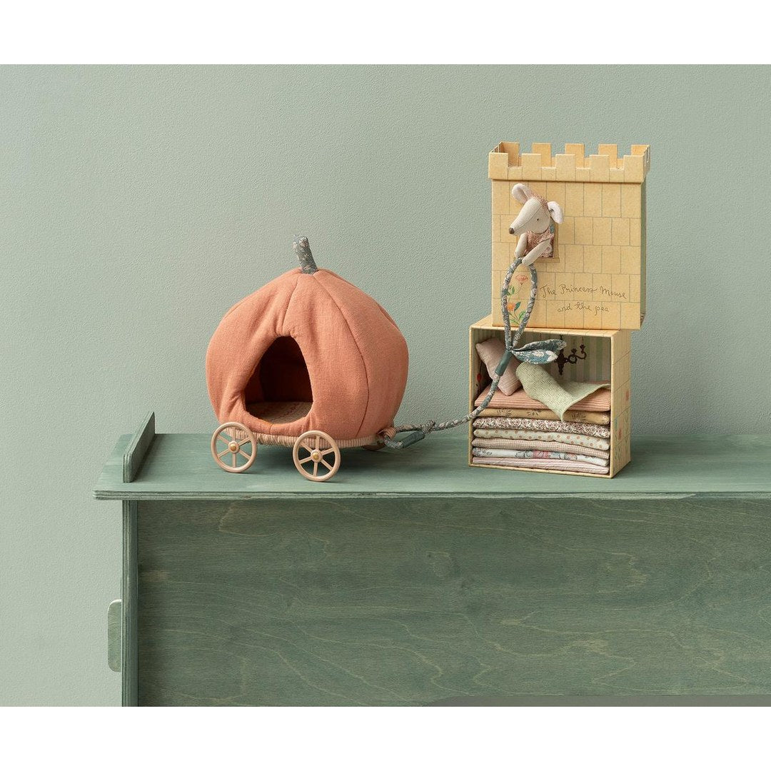 Maileg pumpkin carriage on a green dresser next to the Princess and the Pea castle tower