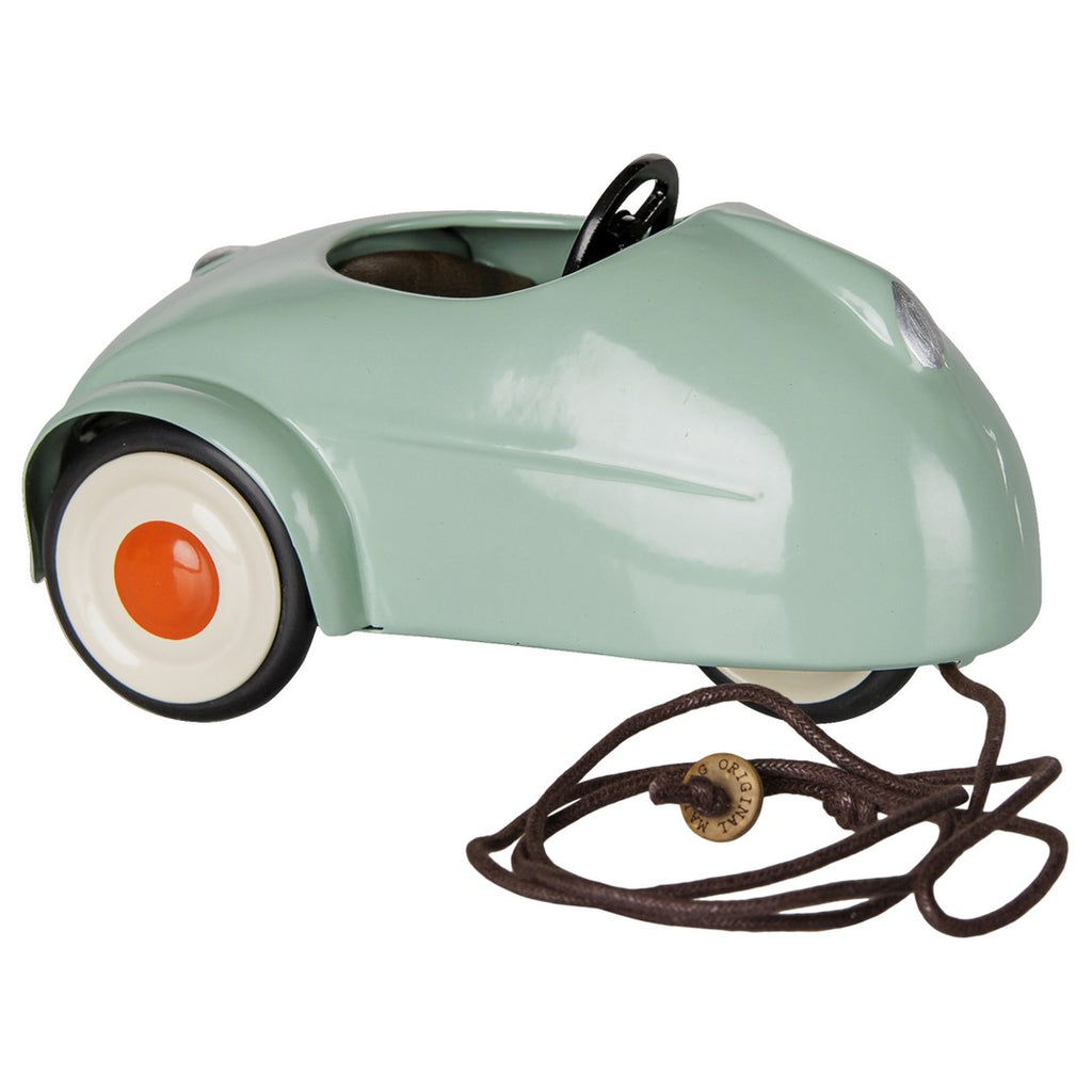 Maileg light mint mouse car, side view with its brown pull cord