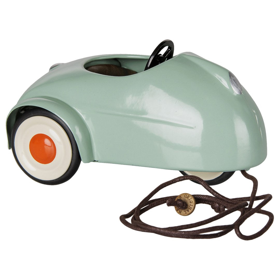 Maileg light mint mouse car, side view with its brown pull cord