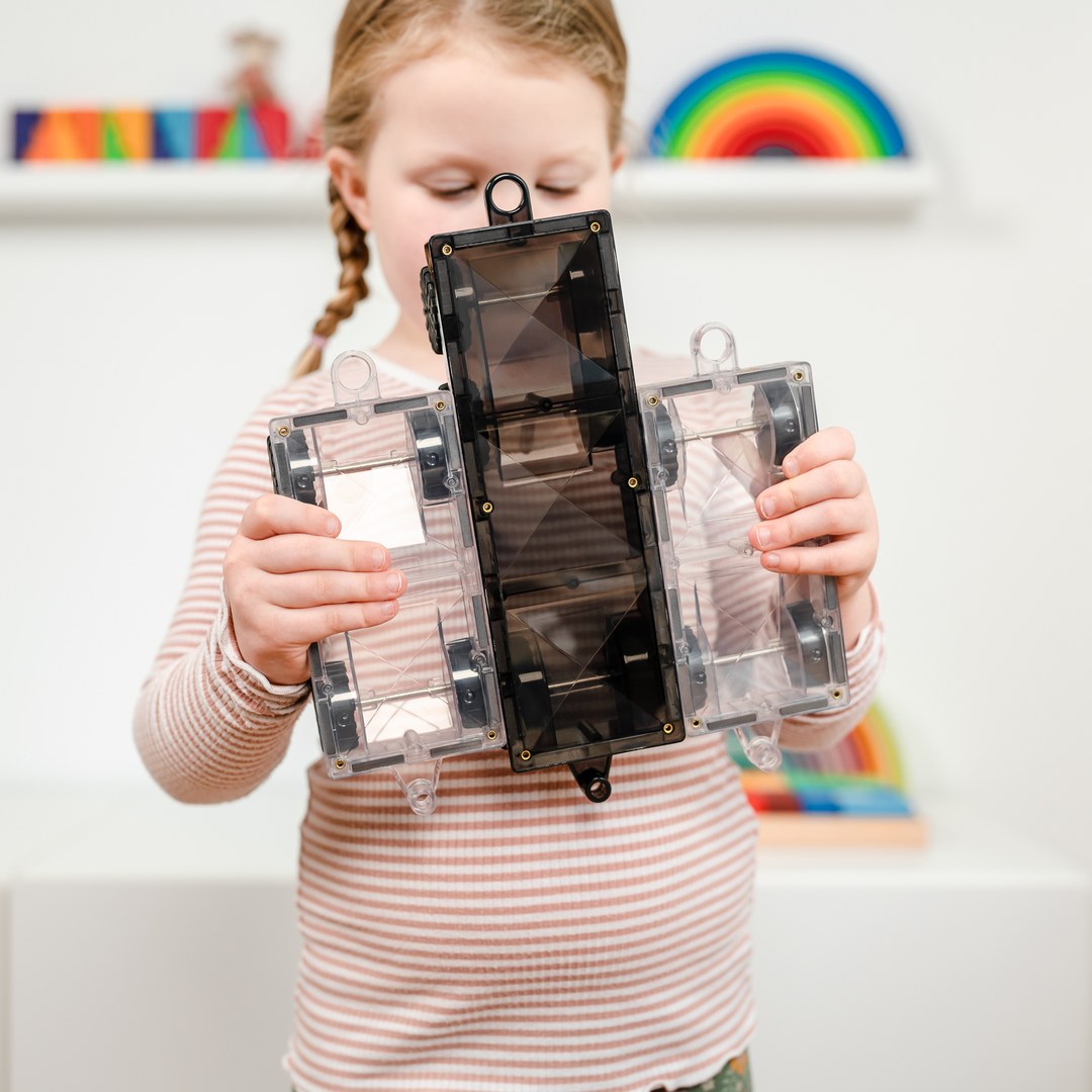 Girl holding up the three CONNETIX motion bases