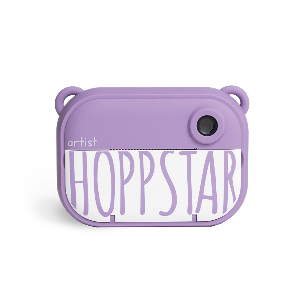 A lavender purple camera 'artist HOPPSTAR' printed on the front, set against a plain white background.