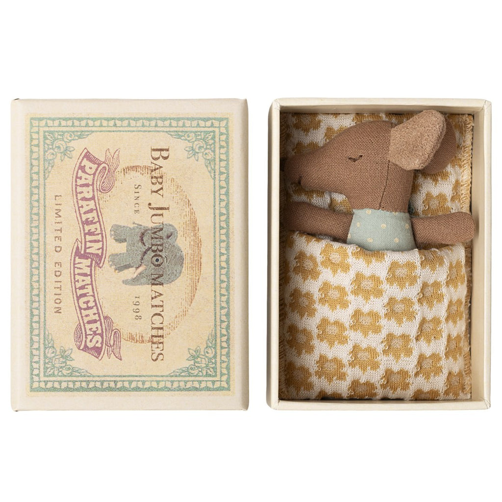 Maileg Sleepy Wakey baby mouse in blue polka dot romper tucked under a yellow floral blanket in its Baby Jumbo matchbox