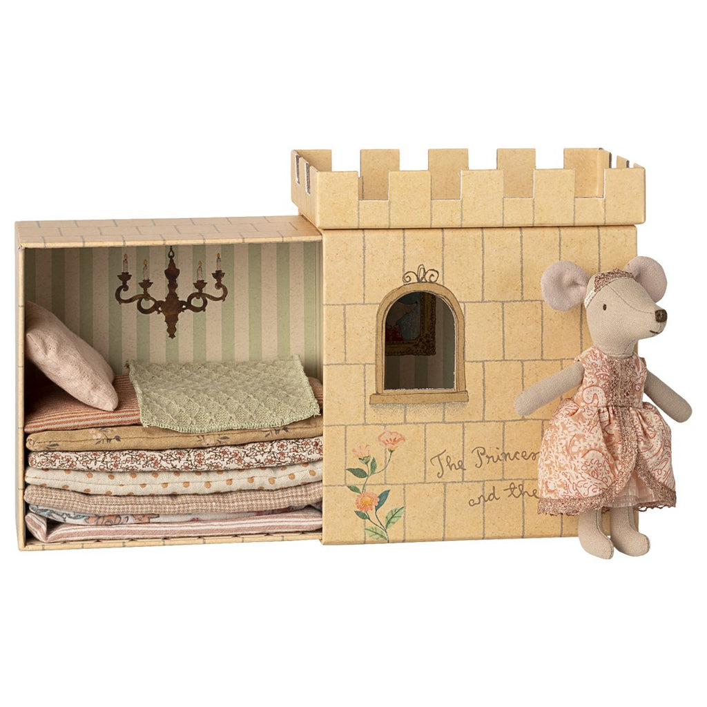 Maileg Princess and the Pea big sister mouse in a paisley dress beside her castle box with a stack of mattresses
