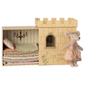 Maileg Princess and the Pea big sister mouse in a paisley dress beside her castle box with a stack of mattresses