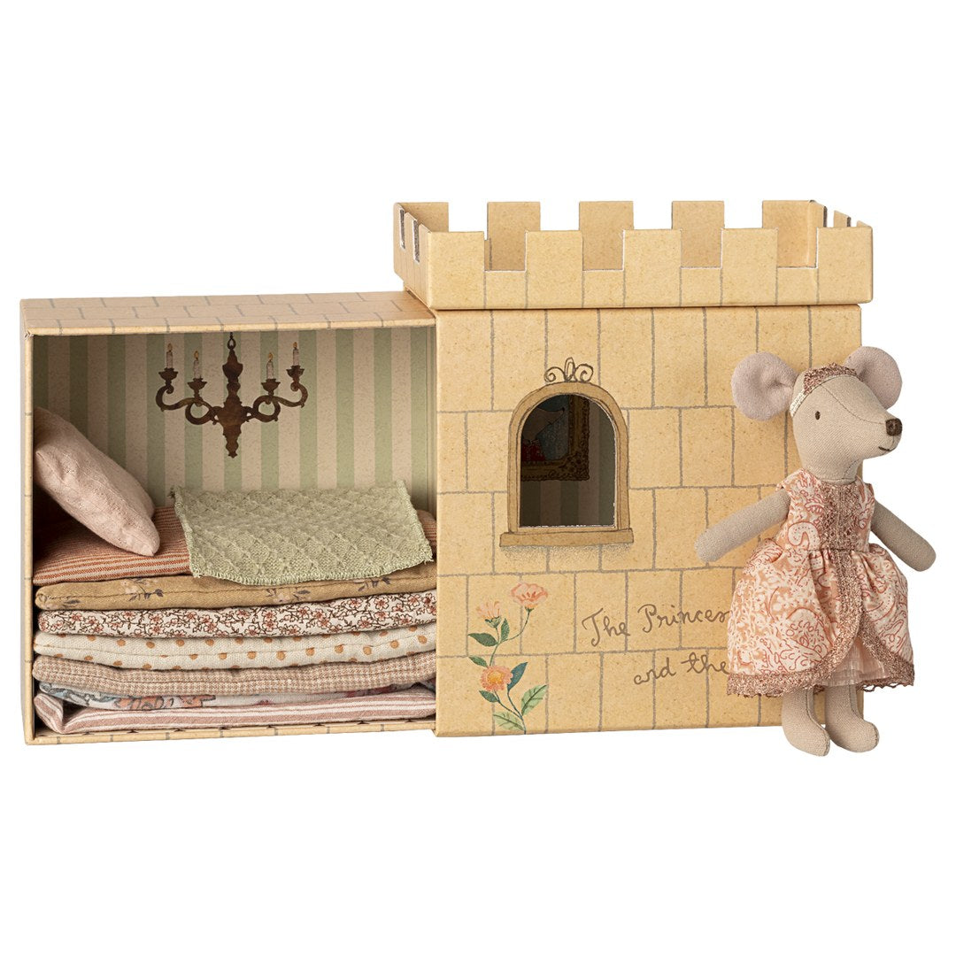Maileg Princess and the Pea big sister mouse in a paisley dress beside her castle box with a stack of mattresses