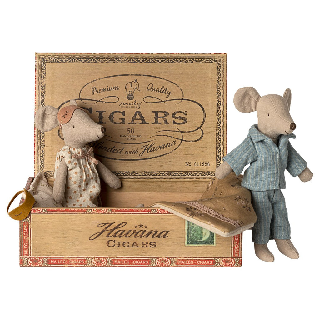 Maileg Mum mouse sitting in the open cigar box bed while Dad mouse in blue striped pyjamas stands beside it