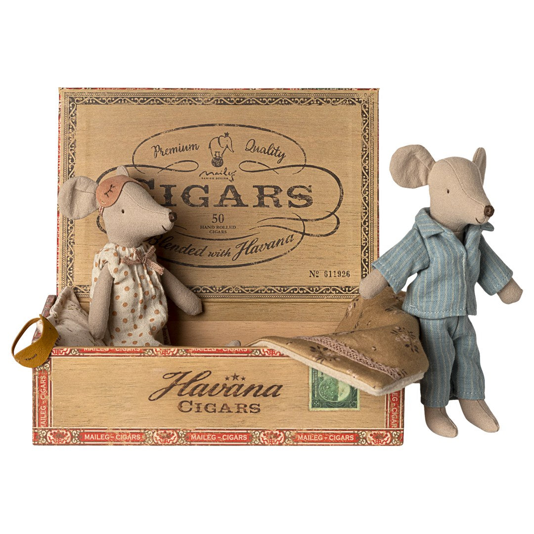 Maileg Mum mouse sitting in the open cigar box bed while Dad mouse in blue striped pyjamas stands beside it