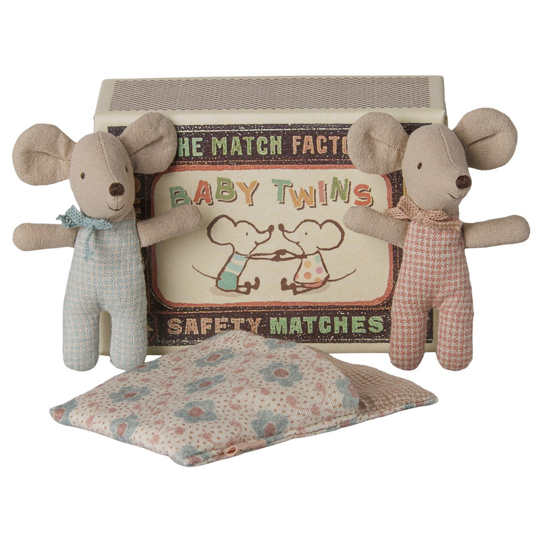 Maileg Twins baby mice standing either side of their Baby Twins matchbox with a floral quilt