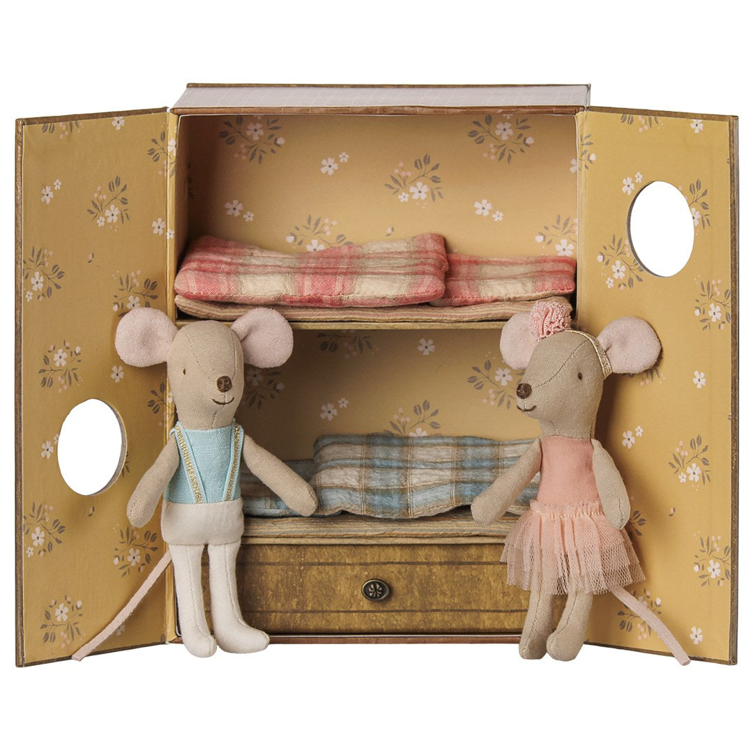Maileg ballet mice, little brother in a blue leotard and little sister in a pink tutu, in front of the open dance studio box with bunk beds