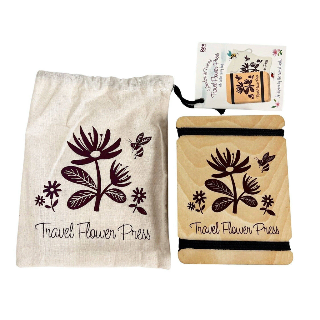 Travel flower press with floral design and matching drawstring bag on a white background