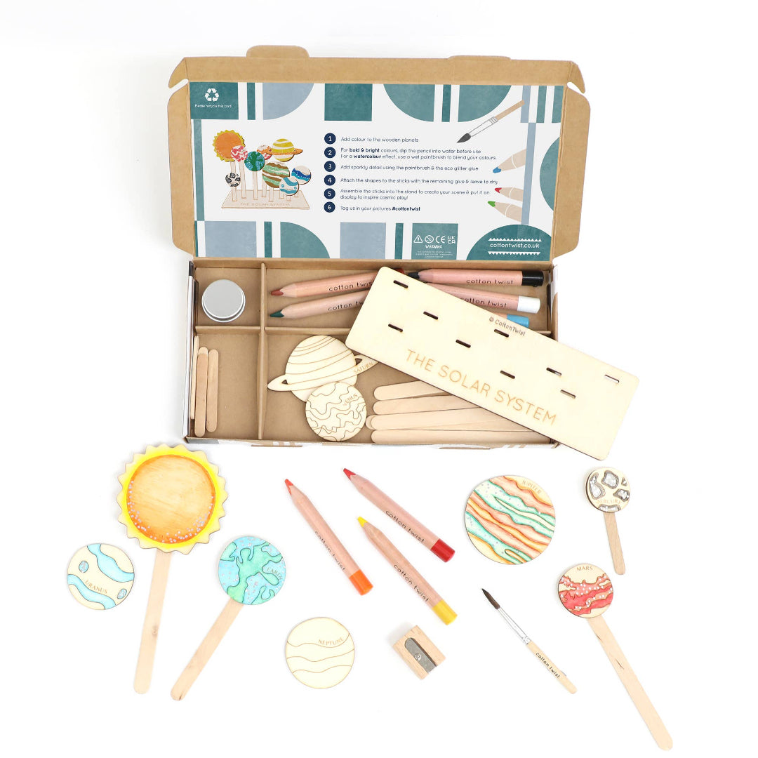 Solar system-themed wooden toy set with packaging on a white background
