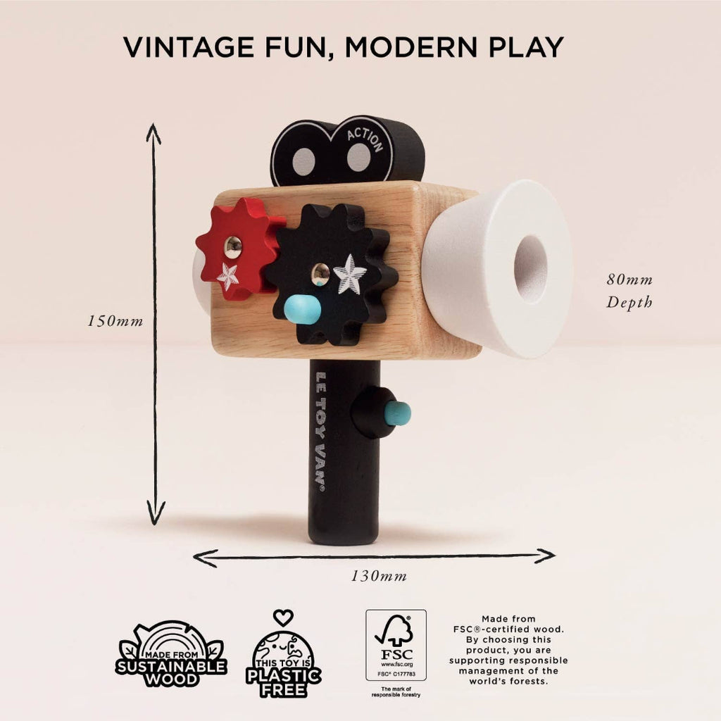 Toy camera with measurements and sustainability certifications on a light pink background