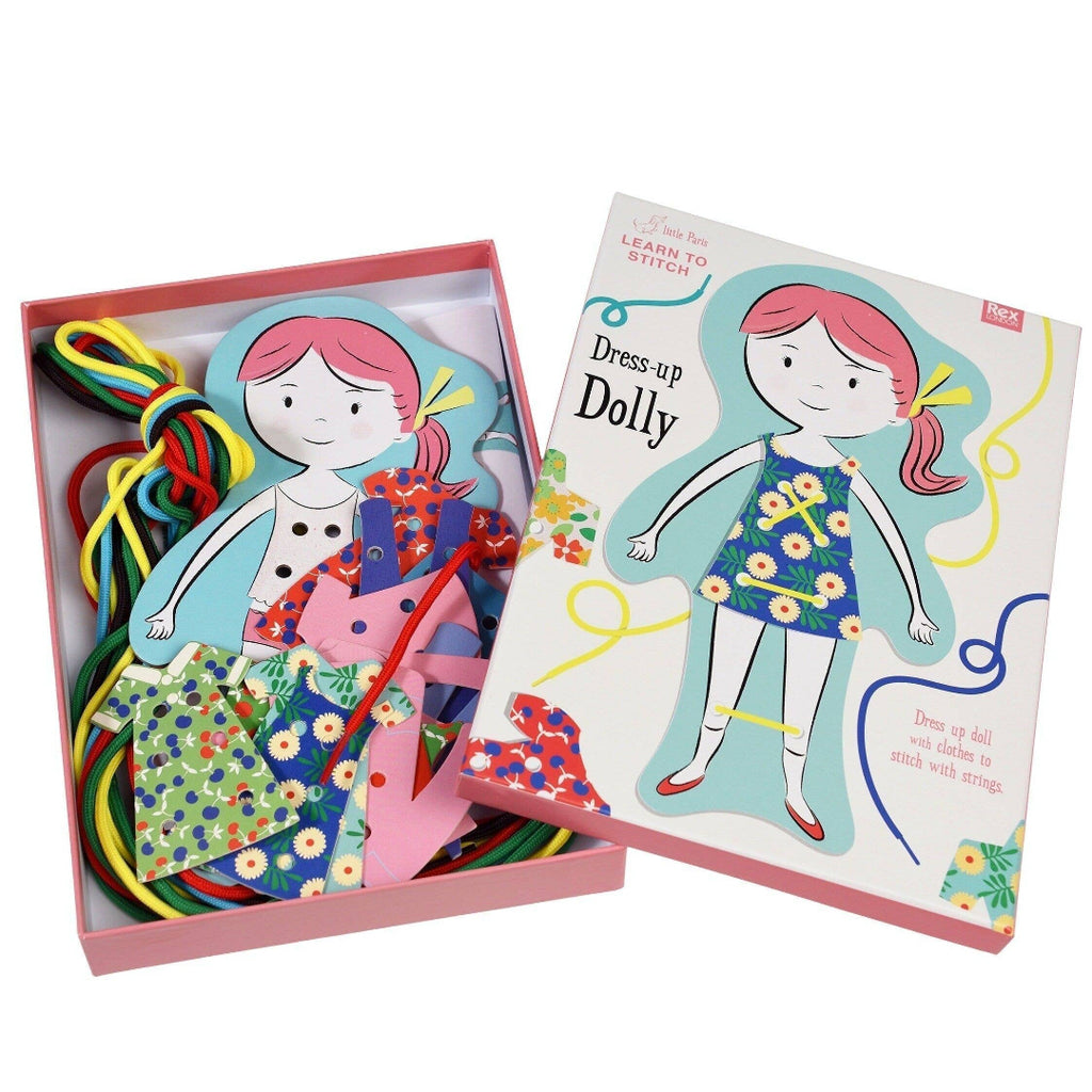 Dress-up Dolly toy set with colorful ribbons and a book on a white background