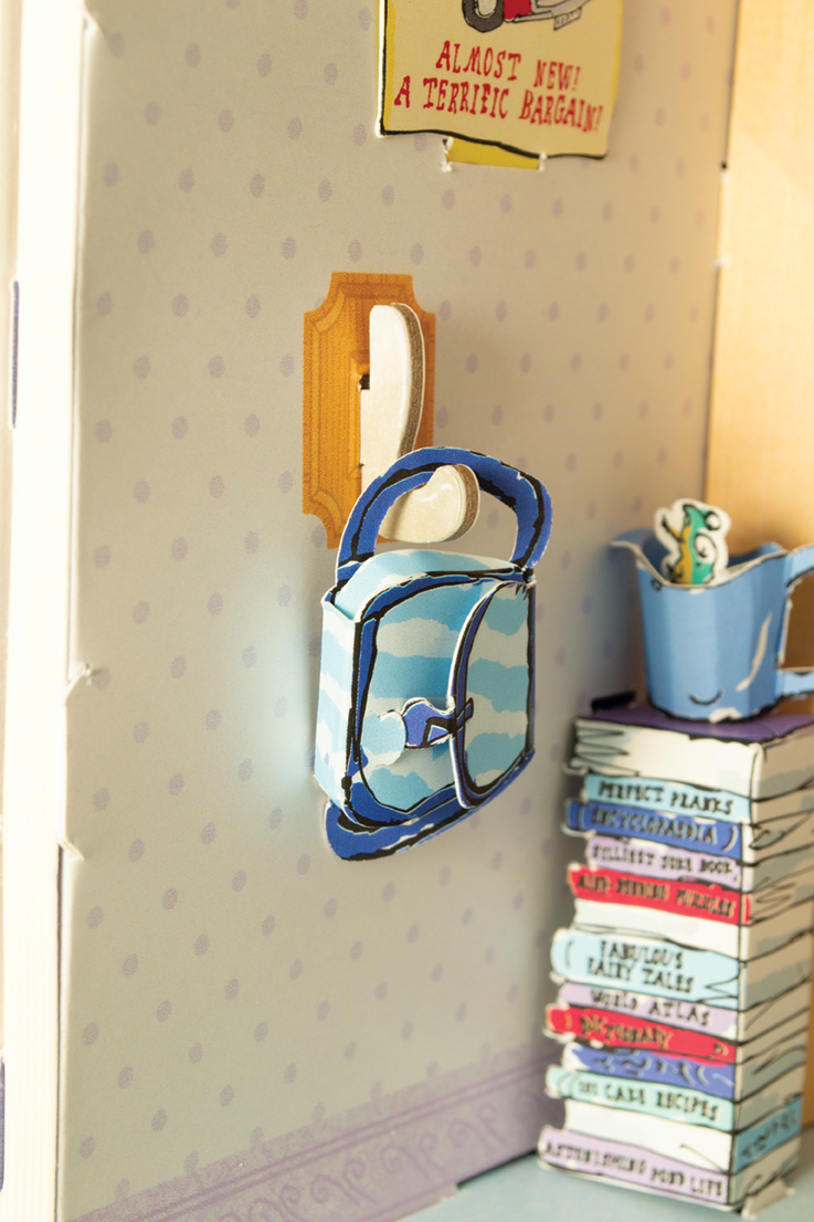 Decorative scene with a blue teapot, teacup, and books on a shelf against a patterned wall.