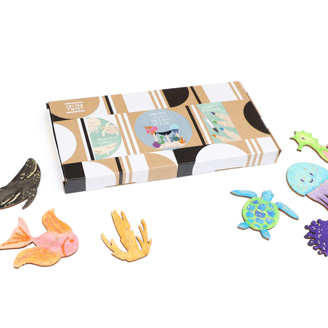 Colorful sea-themed magnets on a white background with a decorative box.