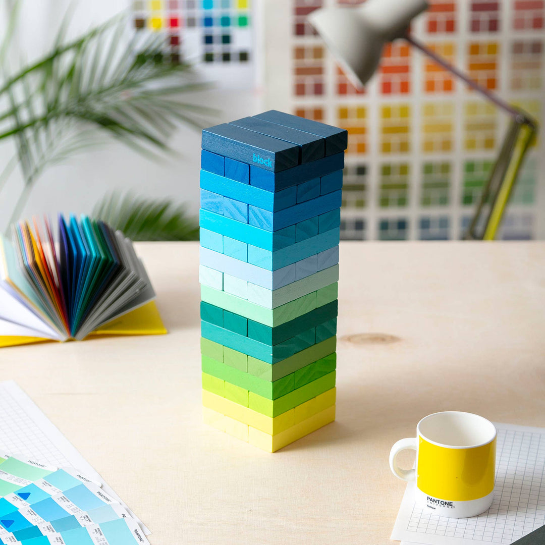 Block Design Warm Gradient Tower, a wooden tumbling tower game with painted blocks in a pink, coral and red gradient, image 4