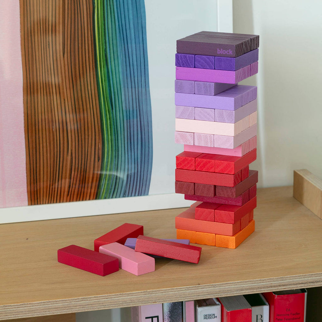 Block Design Warm Gradient Tower, a wooden tumbling tower game with painted blocks in a pink, coral and red gradient, image 6