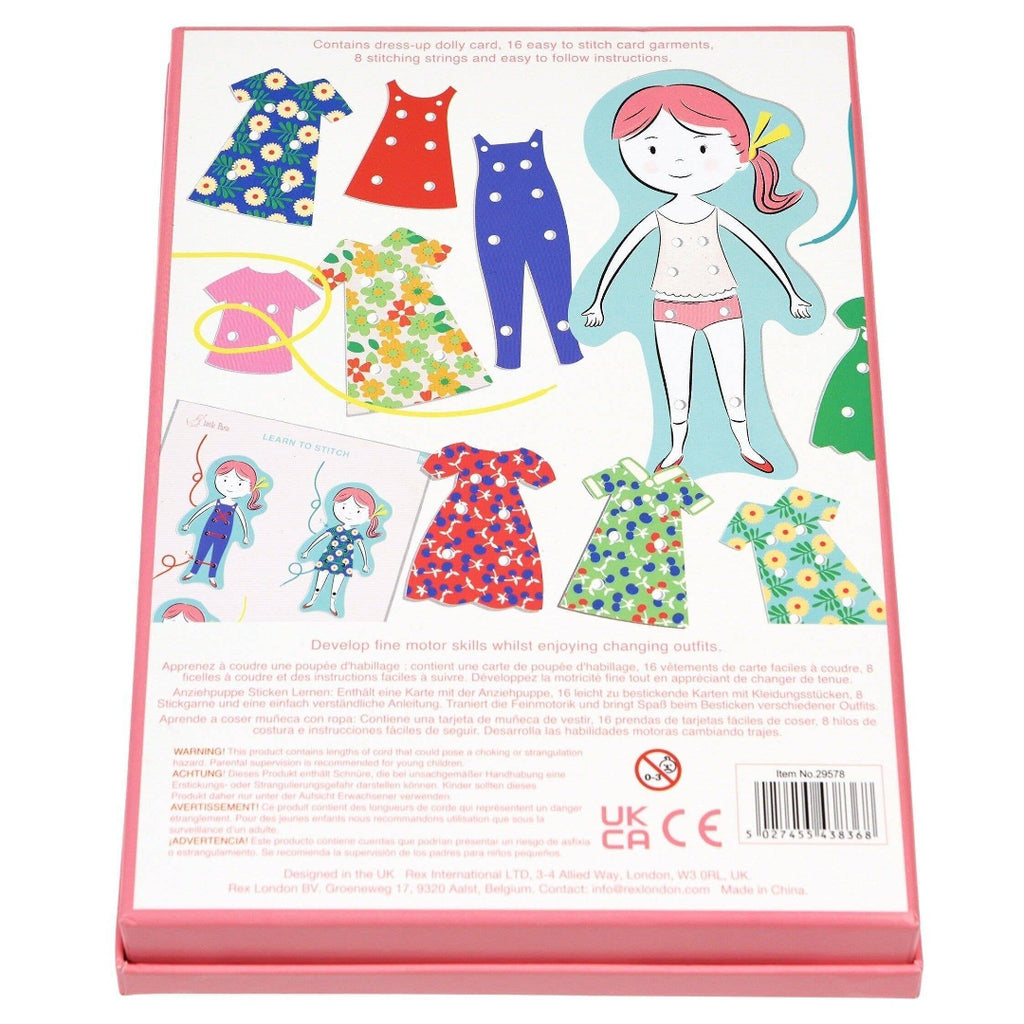 Children's dress-up toy set with paper dolls and clothing on a pink card.