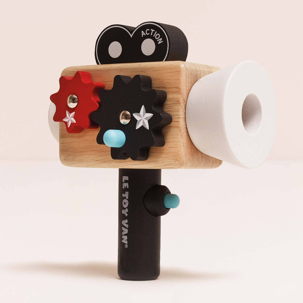 Toy camera with wooden body, colorful lens, and Le Toy Van branding on a beige background
