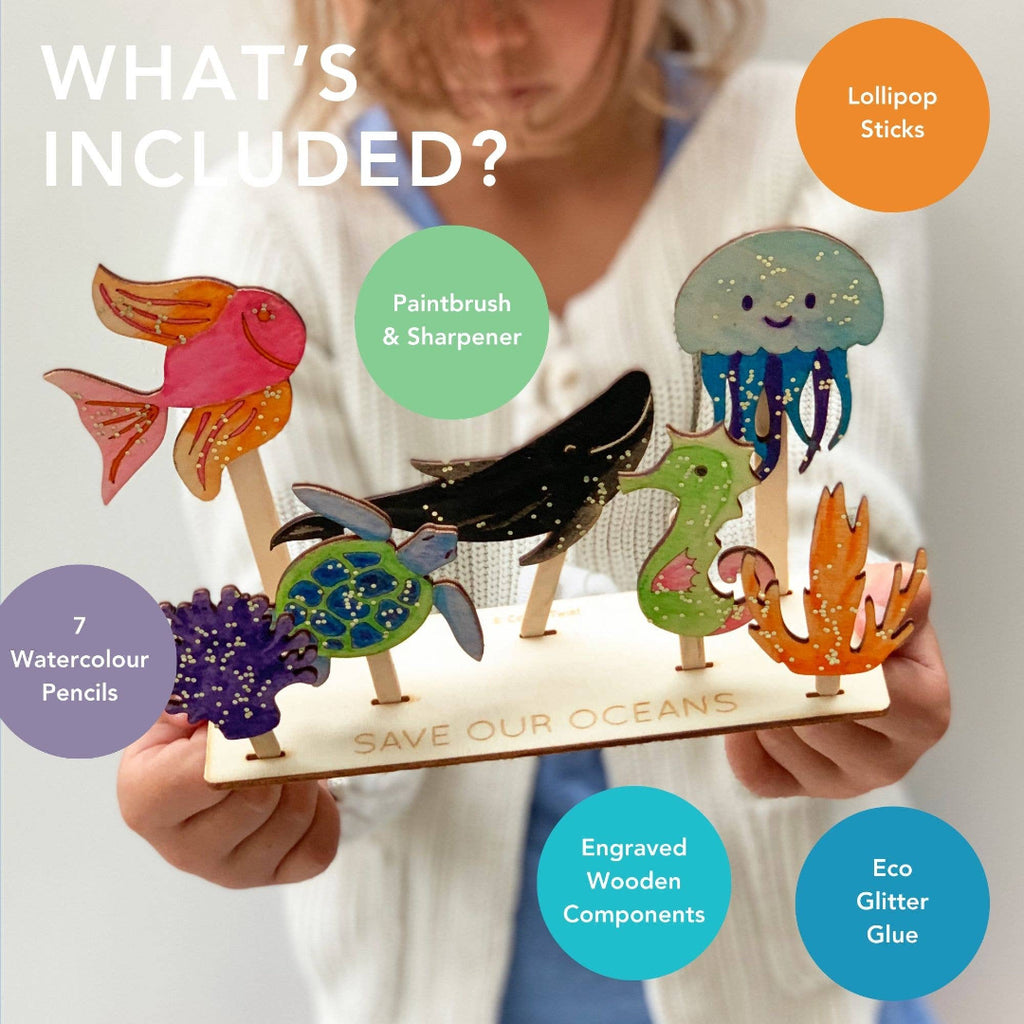 Children's craft set with colorful marine-themed wooden figures and text listing included items.