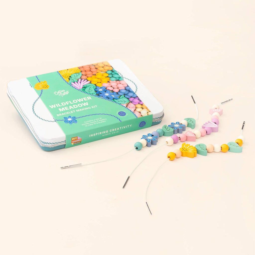 Closed Wildflower Meadow kit tin with loose wooden flower and leaf beads on elastic cords on a cream background