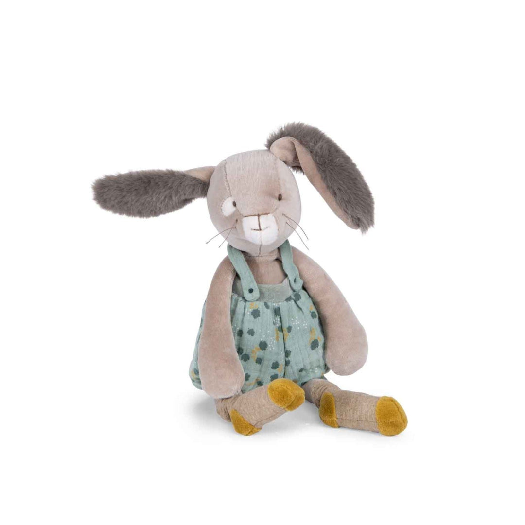 Stuffed bunny toy with a green polka dot outfit on a white background