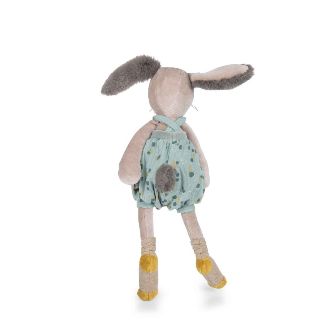 Stuffed toy rabbit wearing a green outfit with yellow socks on a white background