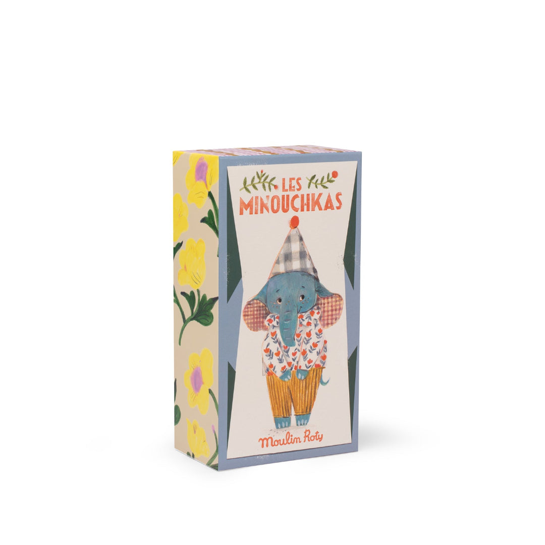 Cardboard box with a colorful design featuring an elephant in a clown outfit and floral elements on a white background.