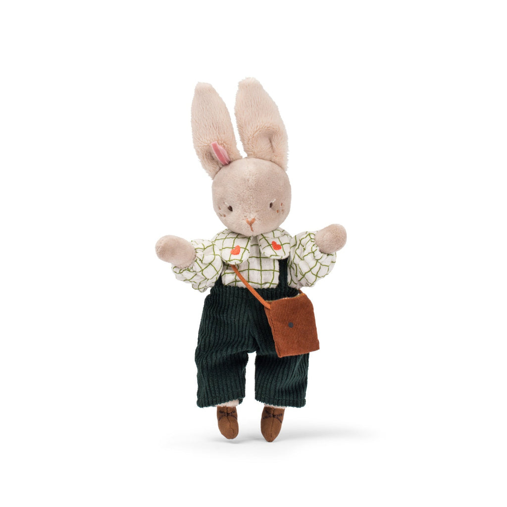 Stuffed rabbit toy wearing overalls and a shirt on a white background