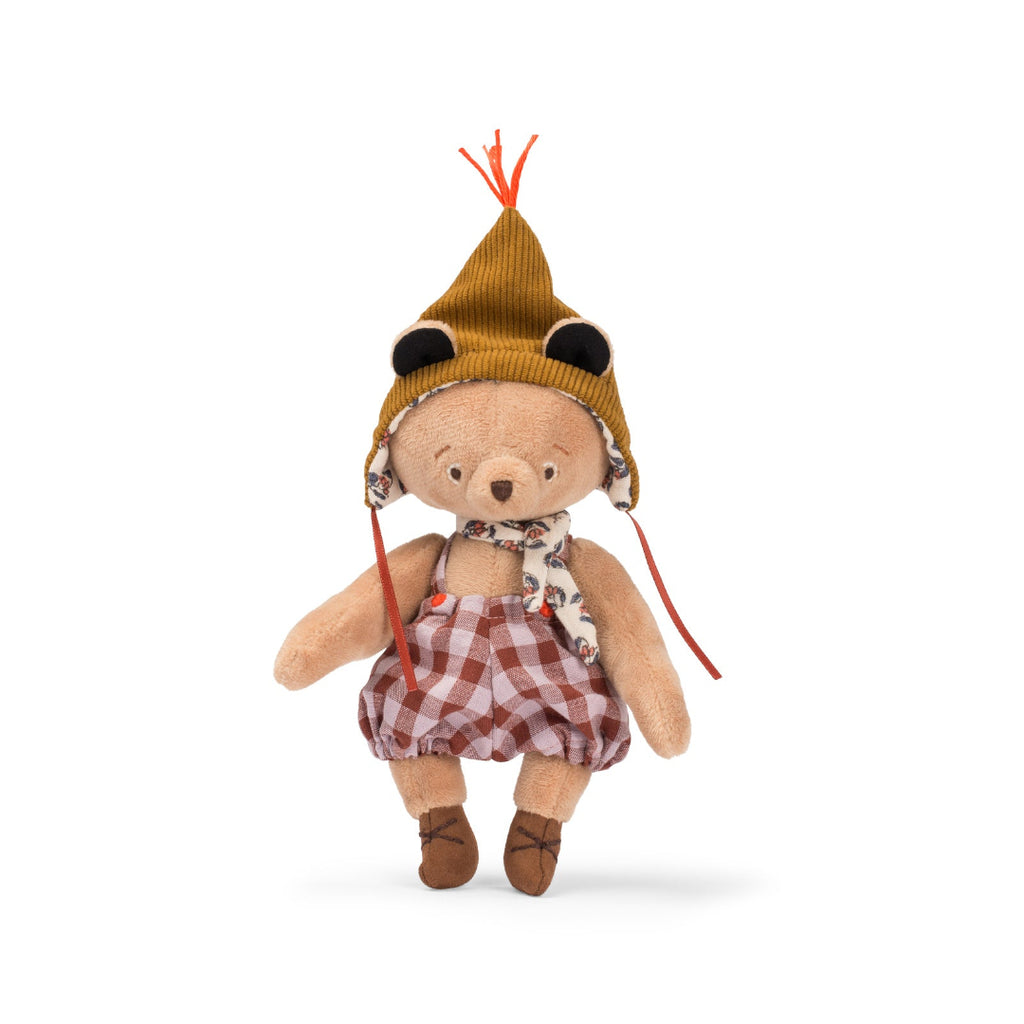 Stuffed teddy bear wearing a hat and plaid outfit on a white background
