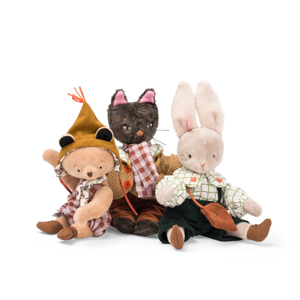 Three plush toys, including a bear, rabbit, and cat, dressed in clothing on a white background.