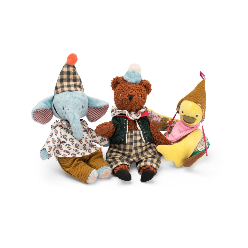 Three stuffed animals, an elephant, a bear, and a duck, wearing hats and outfits on a white background.