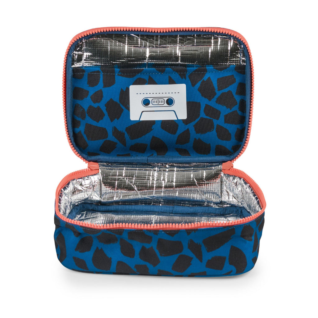 An open zippered lunch bag with a blue and black giraffe print exterior, a silver foil lining, and a cassette tape graphic on the inside lid.