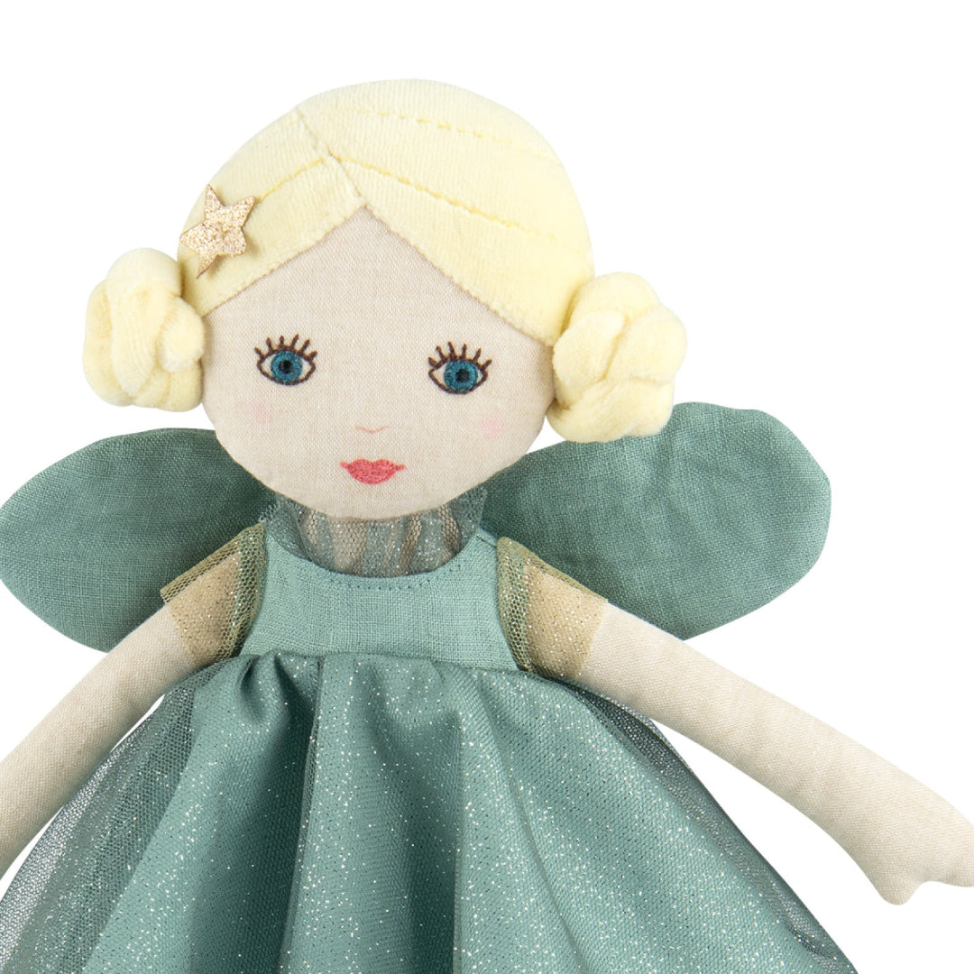 Fabric doll with blonde hair and blue eyes wearing a green dress on a white background