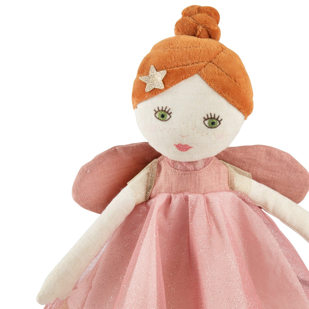 Toy fairy with red hair, pink dress, and star on a white background