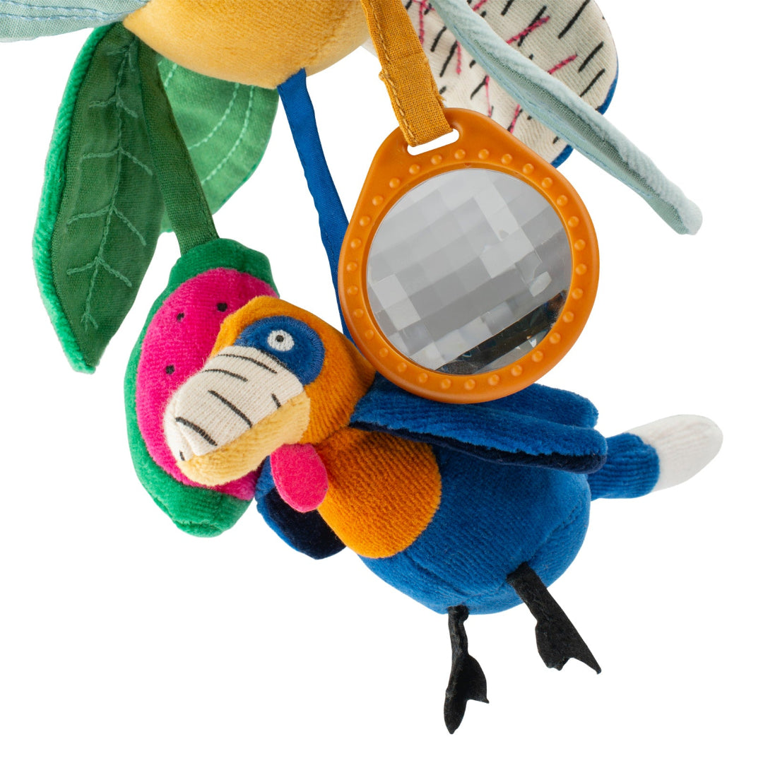 Colorful plush toy resembling a parrot with a mirror on a white background